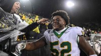 Oregon Ducks defensive lineman A'Mauri Washington (52) reacts with fans after the game against the Iowa Hawkeyes at Kinnick Stadium.