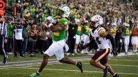 Oregon running back Jay Harris carries the ball for a touchdown as Minnesota defensive back Jai'Onte' McMillan pursues as the Oregon Ducks host the Minnesota Golden Gophers on Nov. 14, 2025, at Autzen Stadium in Eugene, Oregon.
