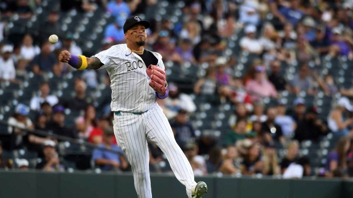 Colorado Rockies third baseman Orlando Arcia (11) throws to first for an out during the seventh inning against the San Diego Padres at Coors Field.