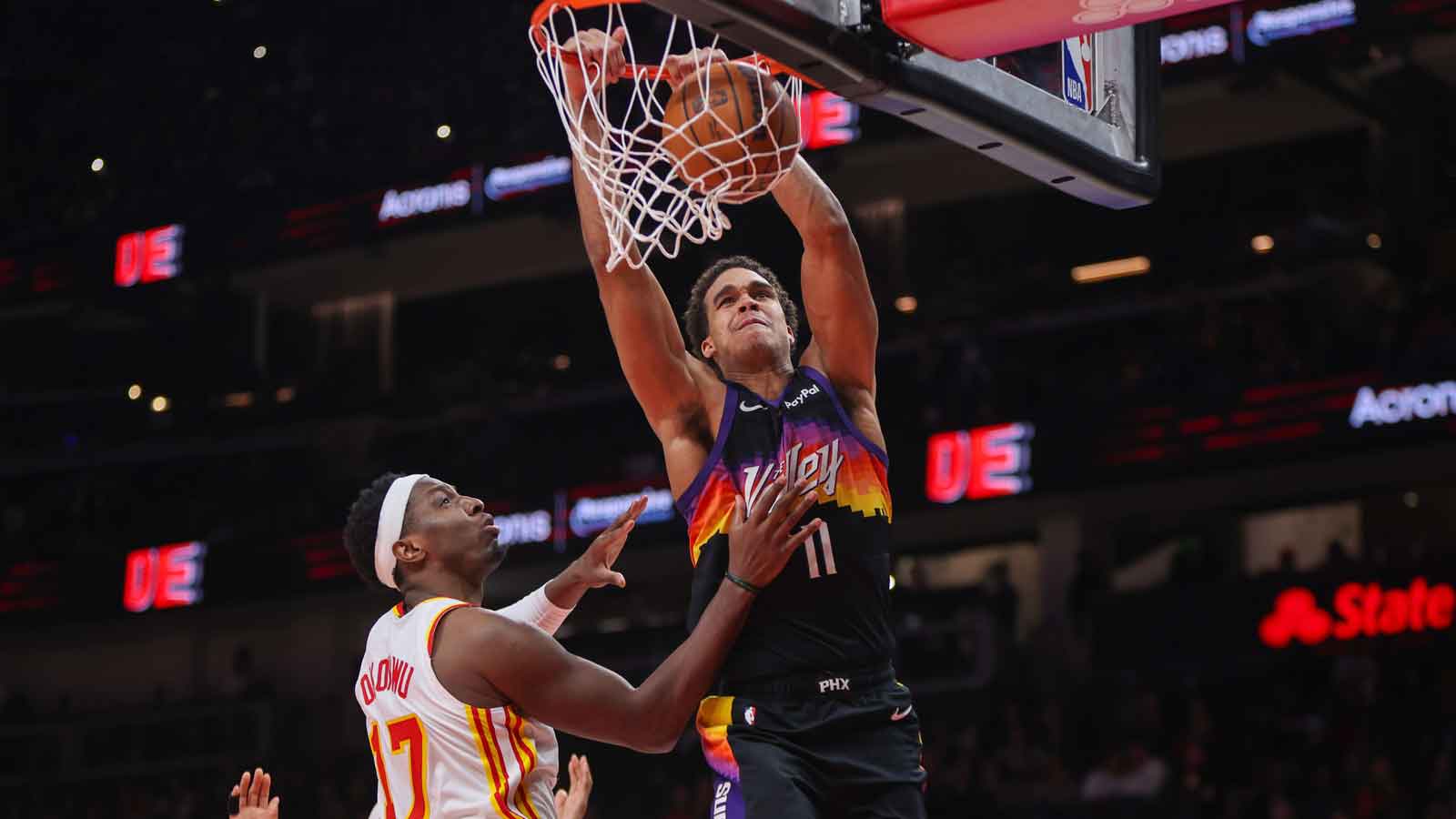 Phoenix Suns forward Oso Ighodaro (11) dunks past Atlanta Hawks forward Onyeka Okongwu (17) in the second quarter at State Farm Arena.