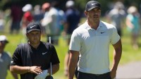 Brooks Koepka and Patrick Reed walk to the sixth tee during the first round of the Travelers Championship at TPC River Highlands