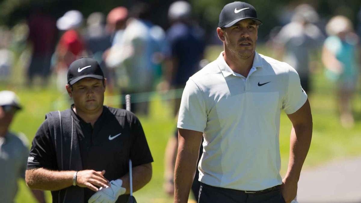 Brooks Koepka and Patrick Reed walk to the sixth tee during the first round of the Travelers Championship at TPC River Highlands