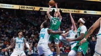 Dallas Mavericks forward Cooper Flagg (32) shoots over Charlotte Hornets forward Moussa Diabate (14) during the second half at American Airlines Center.