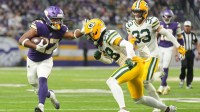 Minnesota Vikings running back Jordan Mason (27) runs the ball against Green Bay Packers cornerback Trevon Diggs (28) during the second quarter at U.S. Bank Stadium.