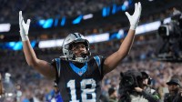 Carolina Panthers wide receiver Jalen Coker (18) reacts after making a touchdown against the Los Angeles Rams in the second half during the NFC Wild Card Round game at Bank of America Stadium.