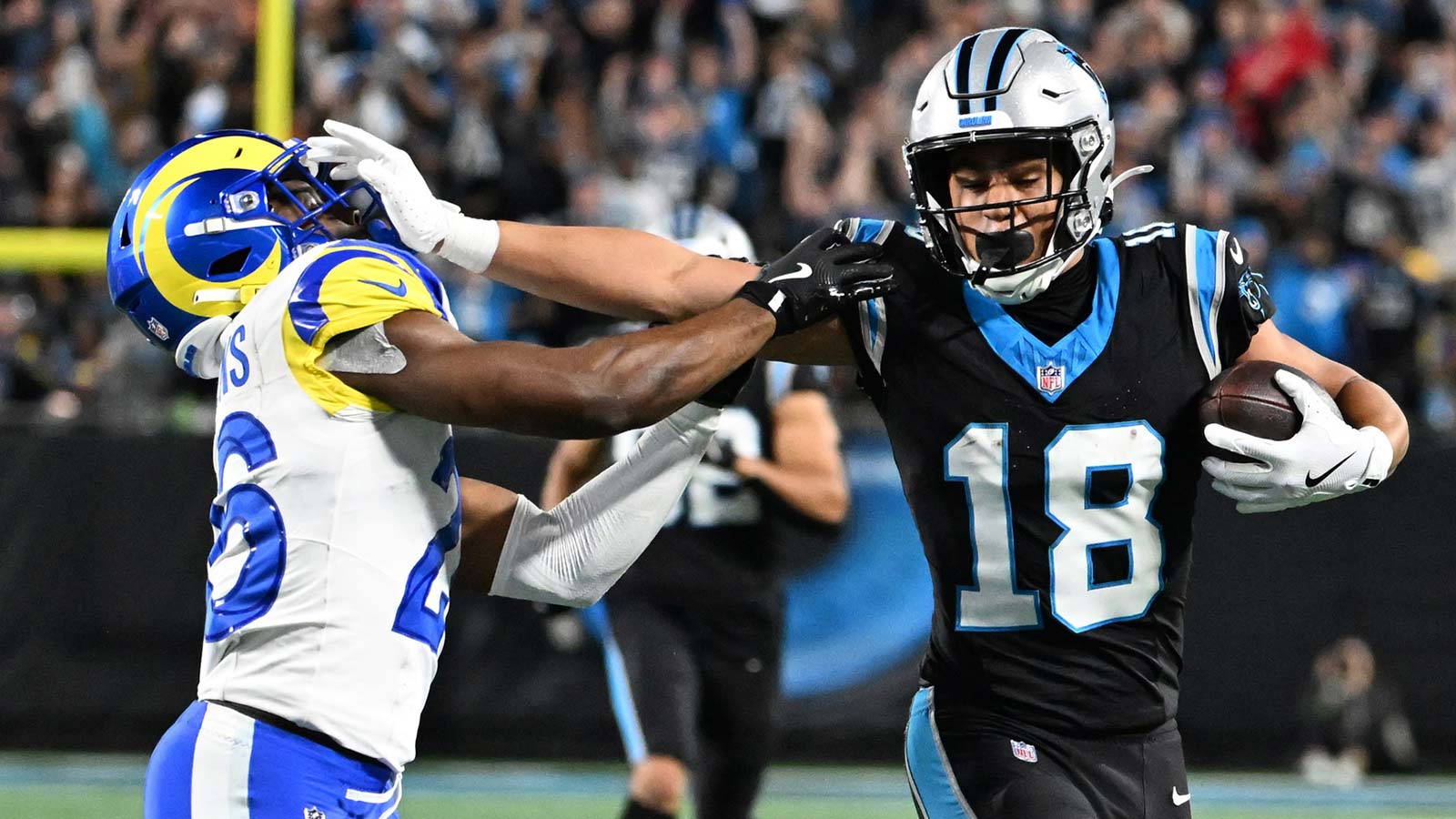 Carolina Panthers wide receiver Jalen Coker (18) makes a catch against Los Angeles Rams safety Kamren Kinchens (26) in the second half during the NFC Wild Card Round game at Bank of America Stadium.