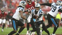 Carolina Panthers quarterback Bryce Young (9) hands off the ball to running back Rico Dowdle (5) in the first half against the Tampa Bay Buccaneers at Raymond James Stadium.