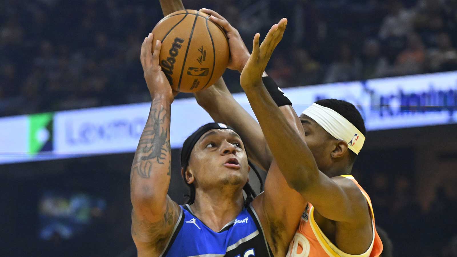 Orlando Magic forward Paolo Banchero (5) looks to the basket beside Cleveland Cavaliers forward Nae'Qwan Tomlin (35) in the first quarter at Rocket Arena.