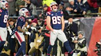 New England Patriots tight end Hunter Henry (85) celebrates after scoring a touchdown during the fourth quarter against the Los Angeles Chargers in an AFC Wild Card Round game at Gillette Stadium.