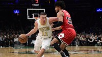 Boston Celtics guard Payton Pritchard (11) controls the ball while Chicago Bulls guard Tre Jones (30) defends during the first half at TD Garden.