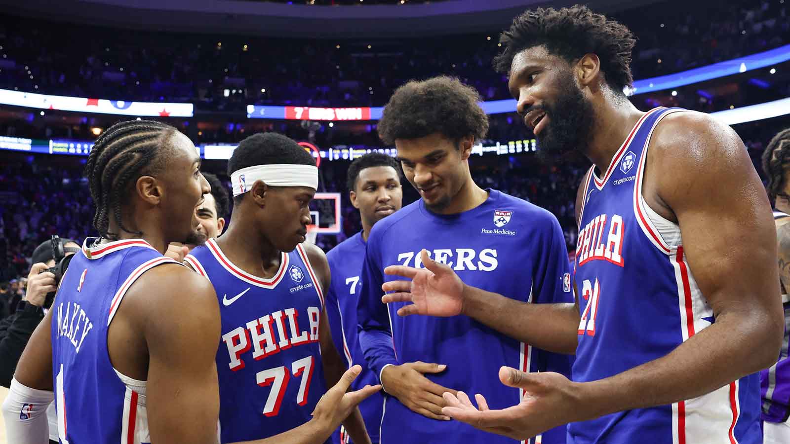 Philadelphia 76ers center Joel Embiid (21) reacts with Philadelphia 76ers guard Tyrese Maxey (L) in front of guard Vj Edgecombe (77) after a victory against the Sacramento Kings at Xfinity Mobile Arena.