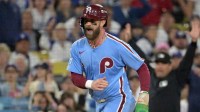 Philadelphia Phillies first baseman Bryce Harper (3) reacts as he scores a run during the fourth inning in game three of the NLDS against the Los Angeles Dodgers during the 2025 MLB playoffs at Dodger Stadium.