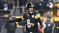 Pittsburgh Steelers quarterback Aaron Rodgers (8) drops back to pass against the Baltimore Ravens during the first half at Acrisure Stadium.