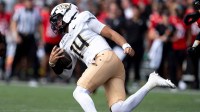 UCF quarterback Cam Fancher (14) runs downfield in the first quarter of the NCAA football game between the Cincinnati Bearcats and UCF Knights.