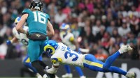 Los Angeles Rams safety Quentin Lake (37) sacks Jacksonville Jaguars quarterback Trevor Lawrence (16) during the second half of an NFL International Series game at Wembley Stadium.