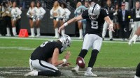 Las Vegas Raiders place kicker Daniel Carlson (8 kicks a 60-yard field goal out of the hold of punter AJ Cole (6) with eight seconds left against the Kansas City Chiefs at Allegiant Stadium.