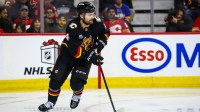 Calgary Flames defenseman Rasmus Andersson (4) skates with the puck against the Buffalo Sabres during the third period at Scotiabank Saddledome.