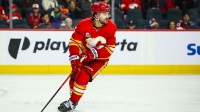 Calgary Flames defenseman Rasmus Andersson (4) skates with the puck against the New York Islanders during the third period at Scotiabank Saddledome.