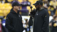 Baltimore Ravens head coach John Harbaugh (left) and Pittsburgh Steelers head coach Mike Tomlin (right) talk on the field before their teams play at Heinz Field.