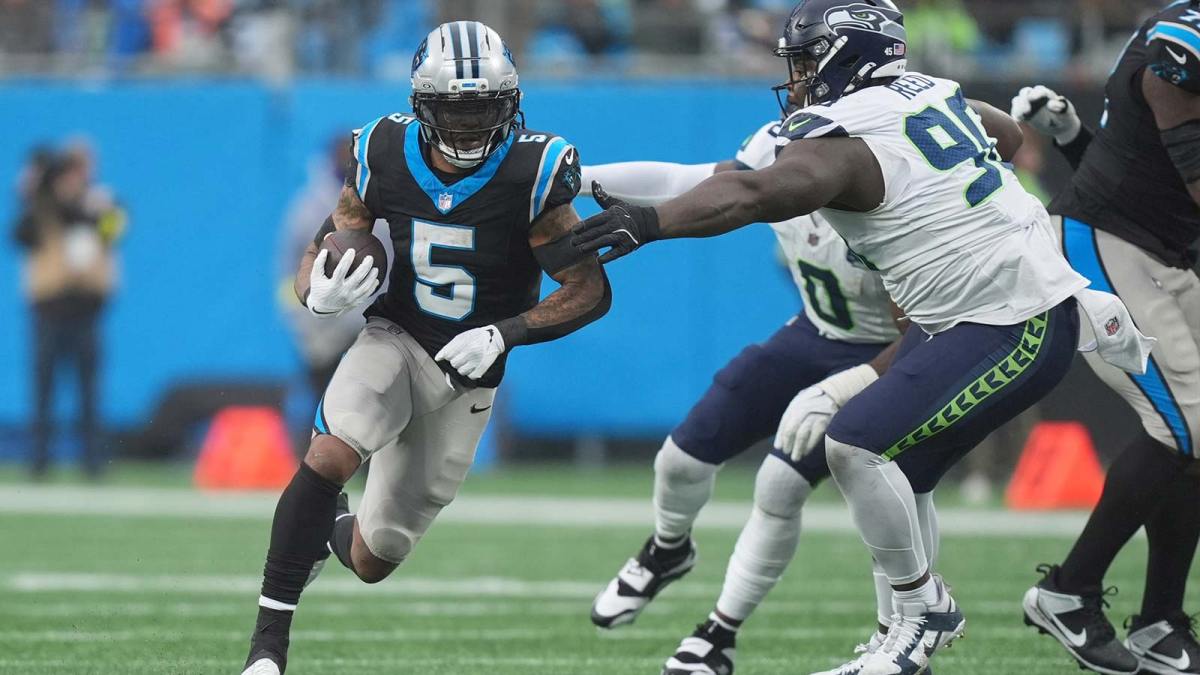 Carolina Panthers running back Rico Dowdle (5) runs the ball against Seattle Seahawks defensive tackle Jarran Reed (90) during the third quarter at Bank of America Stadium