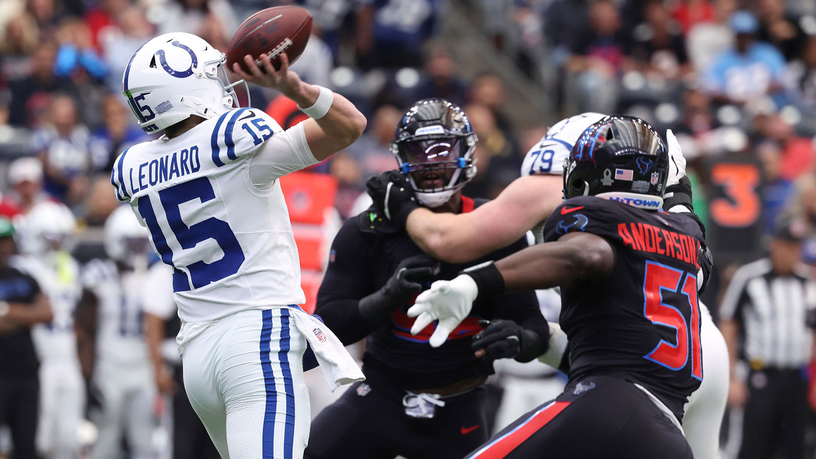 Indianapolis Colts quarterback Riley Leonard (15) throws downfield as Houston Texans defensive end Will Anderson Jr. (51) applies the pressure during the first half at NRG Stadium.
