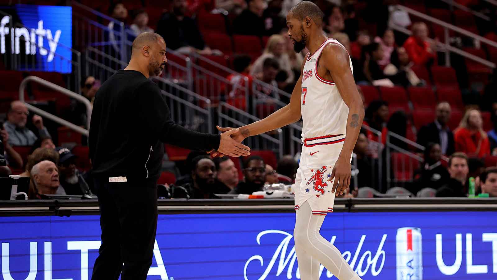 Rockets forward Kevin Durant (7) shakes hands with head coach Ime Udoka after leaving the game against the New Orleans Pelicans during the fourth quarter at Toyota Center