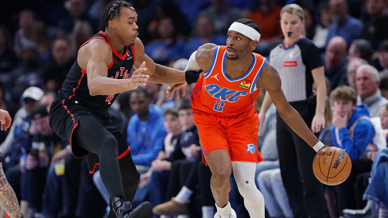 Oklahoma City Thunder guard Shai Gilgeous-Alexander (2) moves the ball around Toronto Raptors forward/guard Scottie Barnes (4) during the second half at Paycom Center. 
