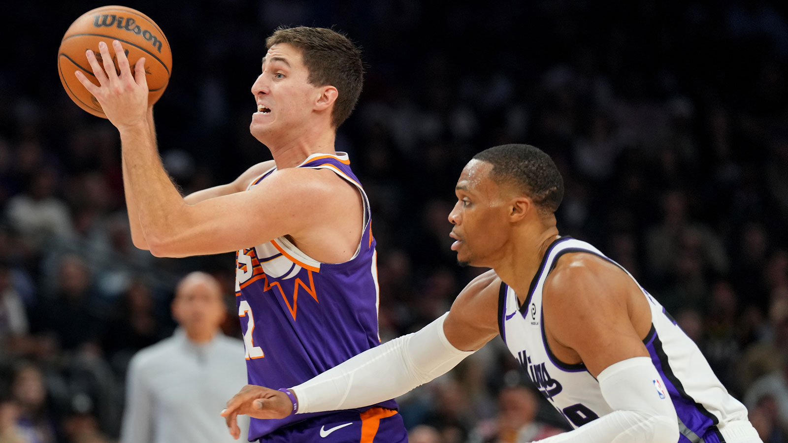Phoenix Suns guard Collin Gillespie (12) protects the ball from Sacramento Kings guard Russell Westbrook (18) during the first half at Mortgage Matchup Center.