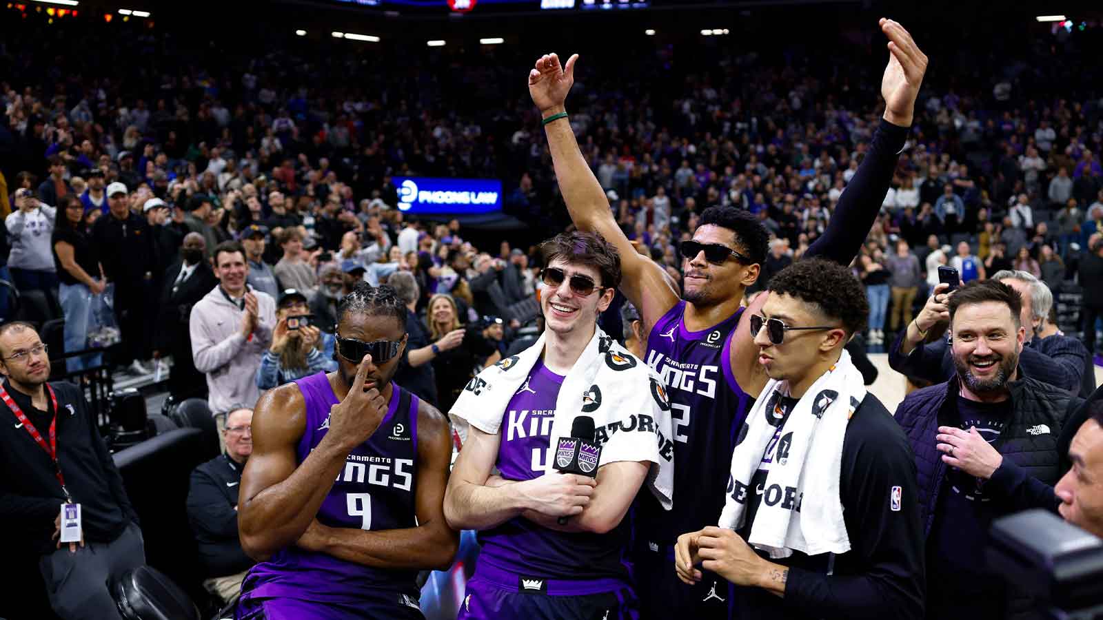 Sacramento Kings forward Precious Achiuwa (9) and center Maxime Raynaud (42) and center Dylan Cardwell (32) and guard Nique Clifford (5) celebrate after lighting the beam in celebration of their victory against the Washington Wizards at Golden 1 Center.