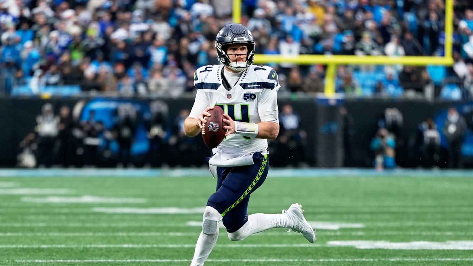 Seattle Seahawks quarterback Sam Darnold (14) looks to throw a pass while scrambling against the Carolina Panthers during the fourth quarter at Bank of America Stadium.