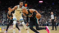 San Antonio Spurs forward/center Victor Wembanyama (1) dribbles against Milwaukee Bucks forward Giannis Antetokounmpo (34) in the first half at Frost Bank Center.