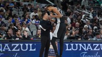 San Antonio Spurs head coach Mitch Johnson talks with forward Victor Wembanyama (1) in the second half against the New York Knicks at Frost Bank Center.