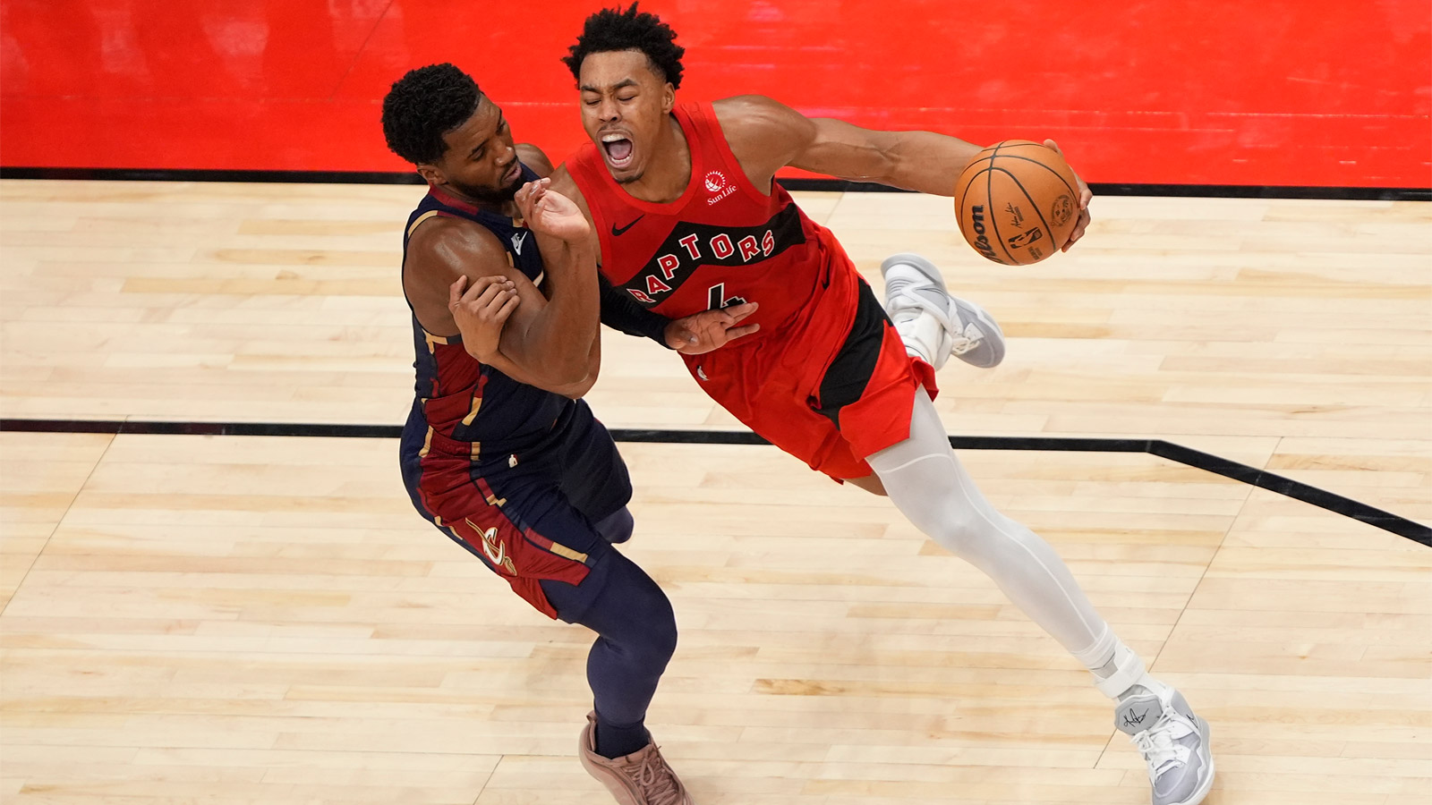 Toronto Raptors guard Scottie Barnes (4) drives to the net against Cleveland Cavaliers guard Donovan Mitchell (45) during the second half at Scotiabank Arena. 