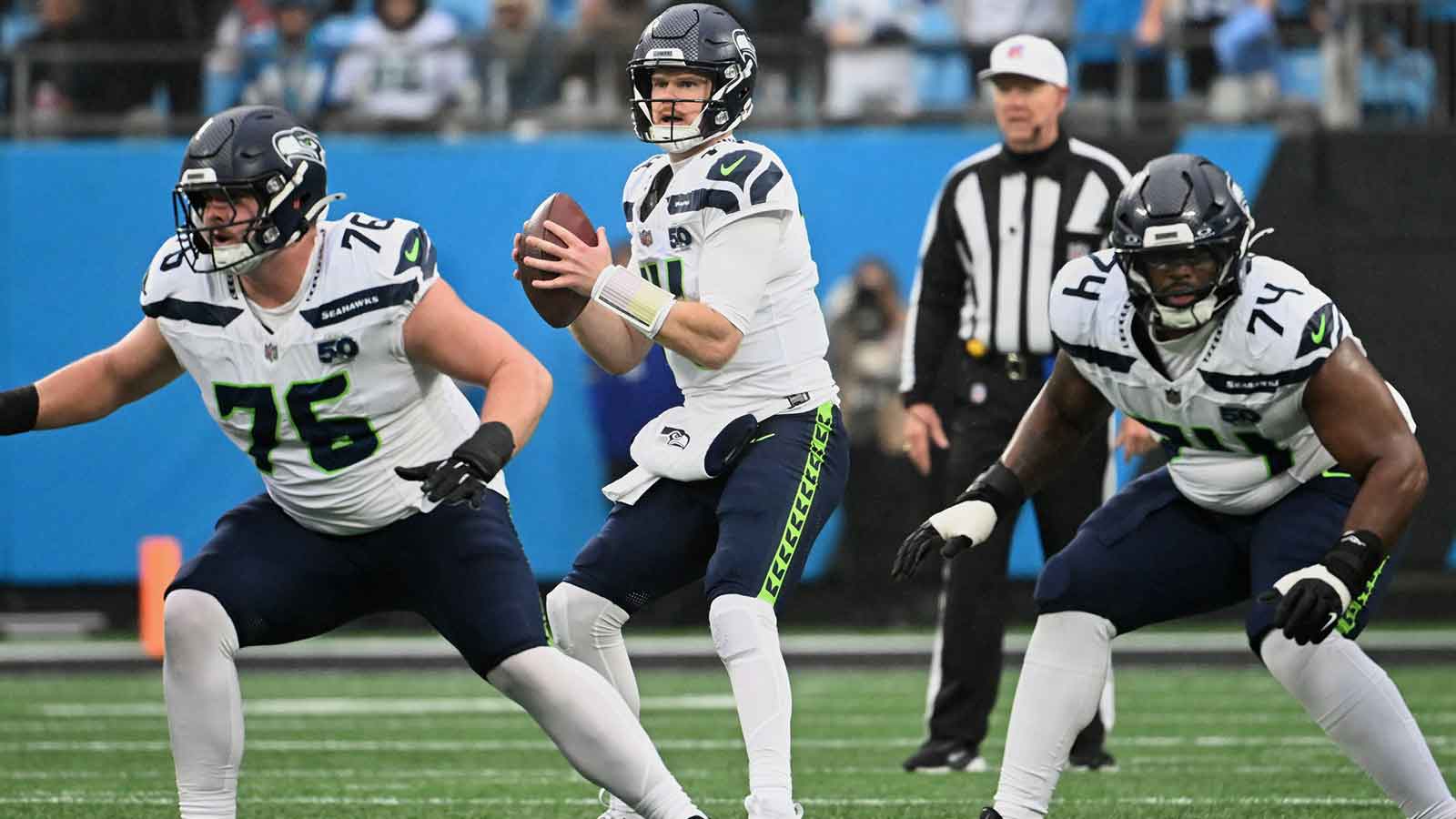 Seattle Seahawks quarterback Sam Darnold (14) looks to throw a pass as guards Grey Zabel (76) and Josh Jones (74) block against the Carolina Panthers during the second quarter at Bank of America Stadium.