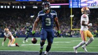 Seattle Seahawks running back Kenneth Walker III (9) scores a touchdown against the San Francisco 49ers during the first half in an NFC Divisional Round game at Lumen Field.
