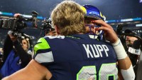 Seattle Seahawks wide receiver Cooper Kupp (10) embraces Los Angeles Rams quarterback Matthew Stafford (9) after the 2026 NFC Championship Game at Lumen Field.