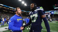Los Angeles Rams head coach Sean McVay greets Seattle Seahawks cornerback Riq Woolen (27) after the 2026 NFC Championship Game at Lumen Field.