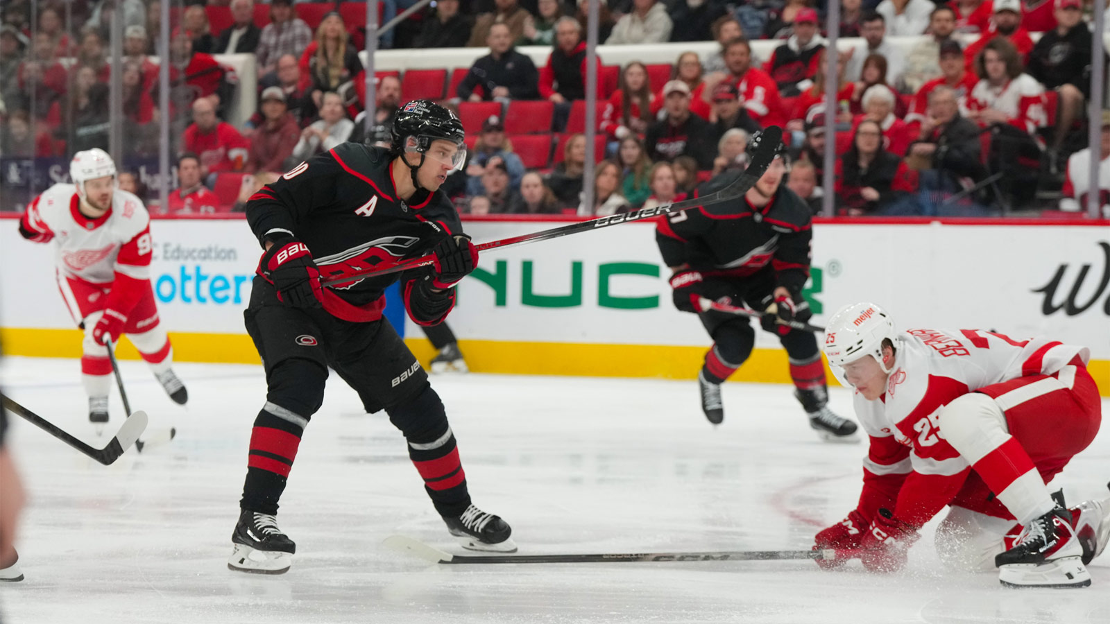 Carolina Hurricanes center Sebastian Aho (20) takes a shot against Detroit Red Wings defenseman Jacob Bernard-Docker (25) during the first period at Lenovo Center.