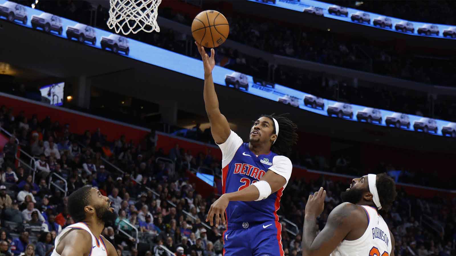 Detroit Pistons guard Jaden Ivey (23) shoots on New York Knicks center Mitchell Robinson (23) in the second half at Little Caesars Arena.