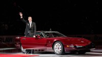 Sergei Fedorov waves at fans as he arrives on ice in a Corvette during his No. 91 jersey retirement ceremony at Little Caesars Arena in Detroit on Monday