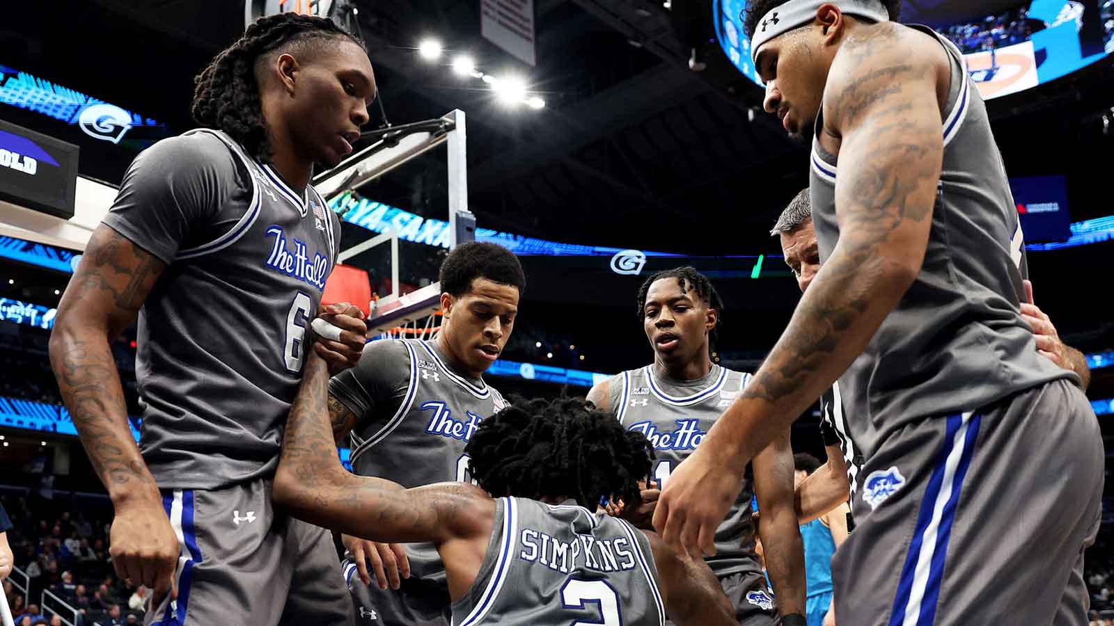 Seton Hall Pirates guard Tajuan Simpkins (2) gets helped off of the floor by his teammates during the second half against the Georgetown Hoyas at Capital One Arena. 