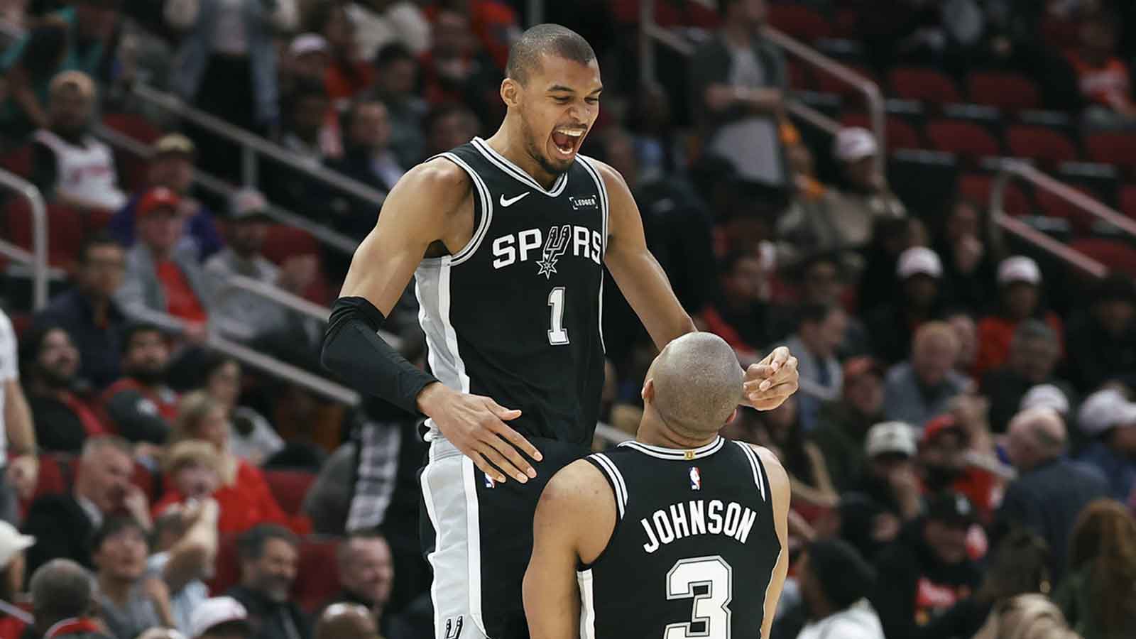 Spurs forward Victor Wembanyama (1) celebrates with forward Keldon Johnson (3) after Johnson scores a basket during the fourth quarter against the Houston Rockets at Toyota Center