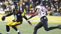 Pittsburgh Steelers quarterback Aaron Rodgers (8) avoids the sack by Baltimore Ravens linebacker Tavius Robinson (95) during the first half at Acrisure Stadium