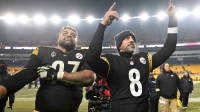 Pittsburgh Steelers quarterback Aaron Rodgers (8) and defensive tackle Cameron Heyward (97) celebrate after defeating the Baltimore Ravens at Acrisure Stadium.