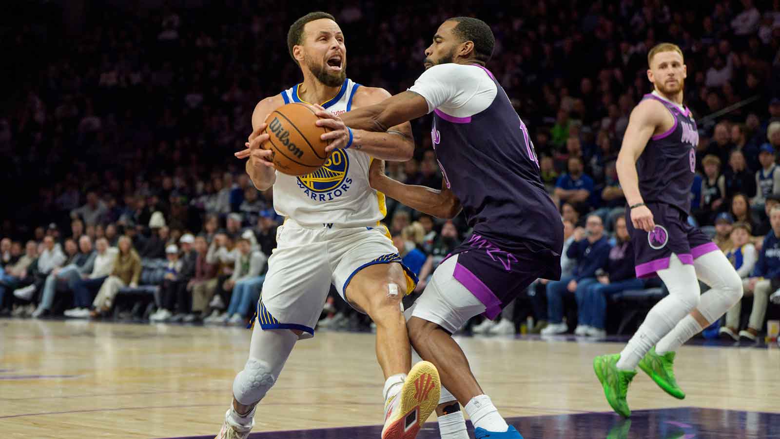 Golden State Warriors guard Stephen Curry (30) is fouled by Minnesota Timberwolves guard Mike Conley (10) in the fourth quarter at Target Center.