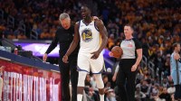 Golden State Warriors forward Draymond Green (23) walks towards the team bench with head coach Steve Kerr after a play against the Memphis Grizzlies in the third quarter at the Chase Center.