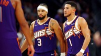 Suns guard Devin Booker (1) and forward Dillon Brooks look serious
