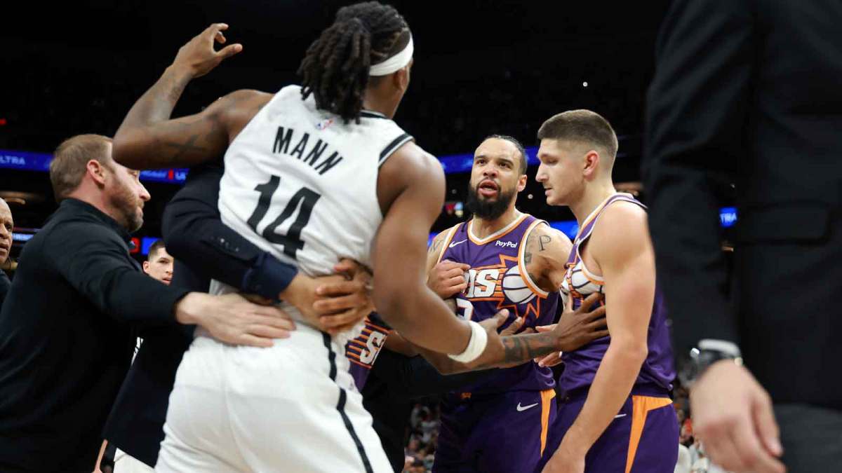 Brooklyn Nets guard Terance Mann (14) is separated from Phoenix Suns forward Dillon Brooks (3) during a fight in the second half at Mortgage Matchup Center.