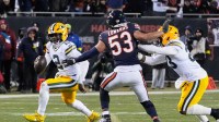 Green Bay Packers quarterback Malik Willis (2) runs with the ball against Chicago Bears linebacker T.J. Edwards (53) during overtime at Soldier Field.