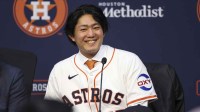Houston Astros pitcher Tatsuya Imai smiles during a press conference.